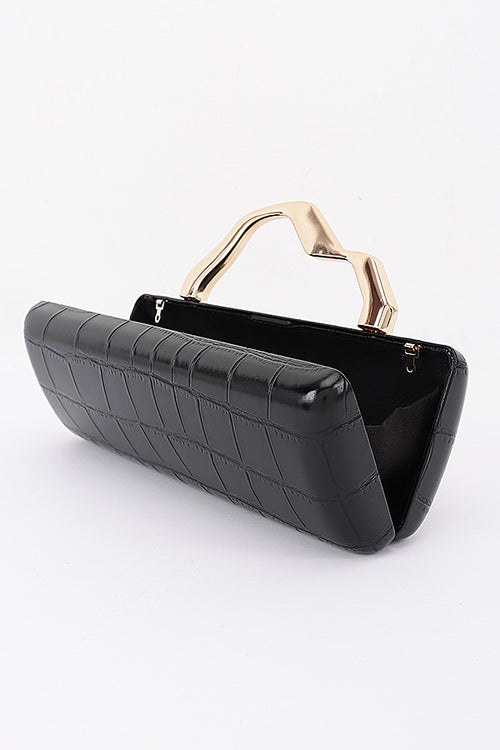 Celeste black croc-embossed clutch with sculptural gold-tone handle, angled front view